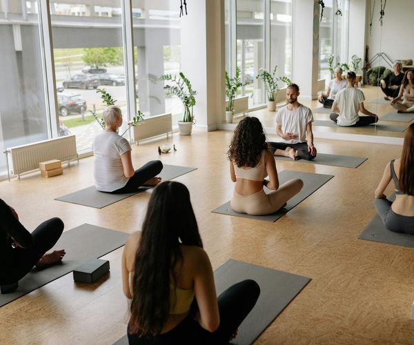 Clean and tranquil yoga studio interior with mats and plants.